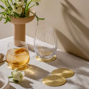 Masion Lustré coasters styled with glasses on table